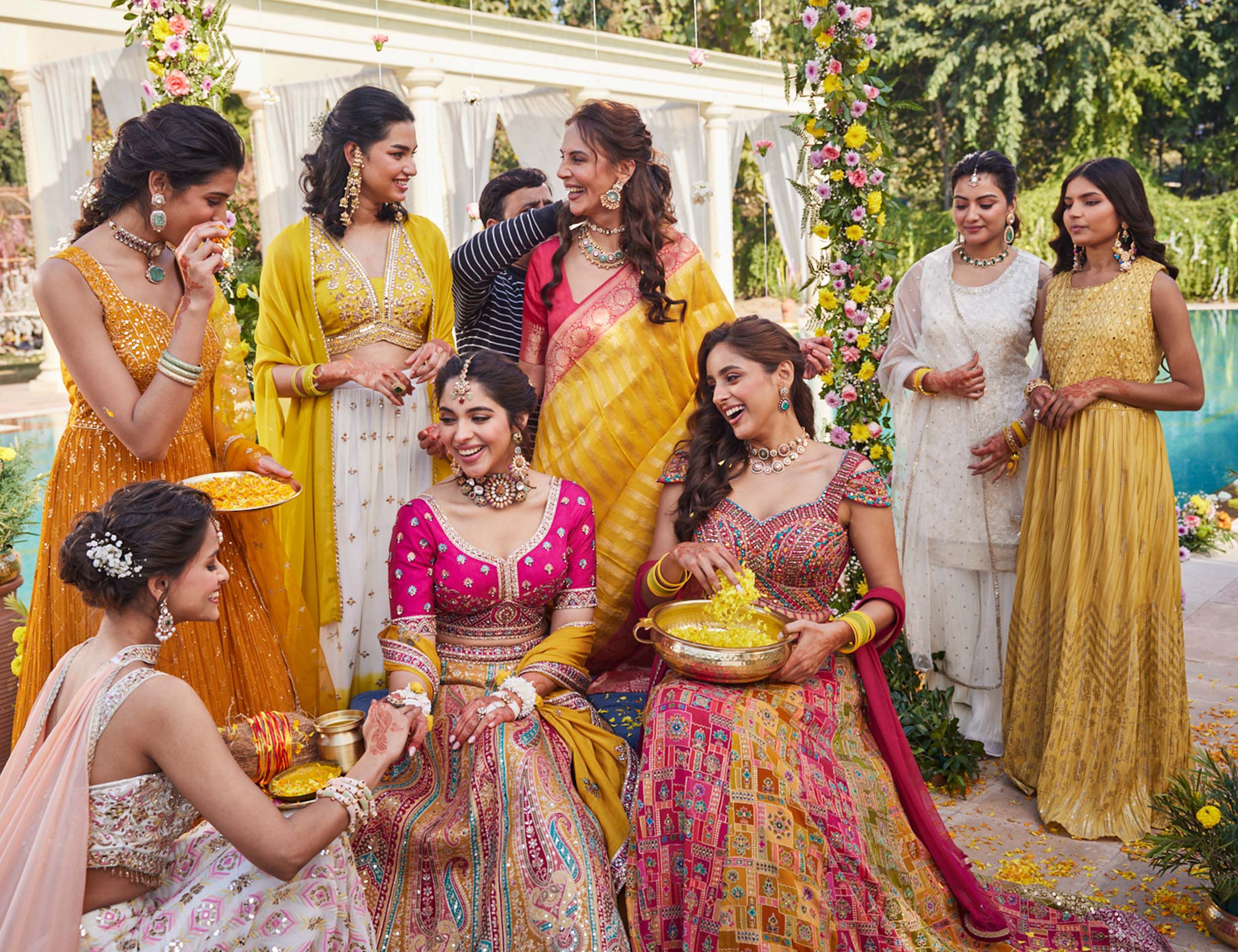 Women wearing designer lehengas in haldi ceremony